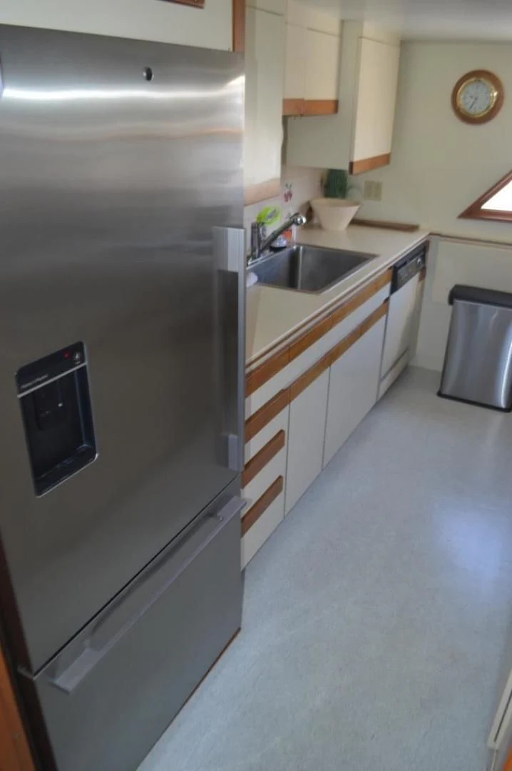a kitchen with a stainless steel refrigerator aboard ENCORE V Yacht for Sale