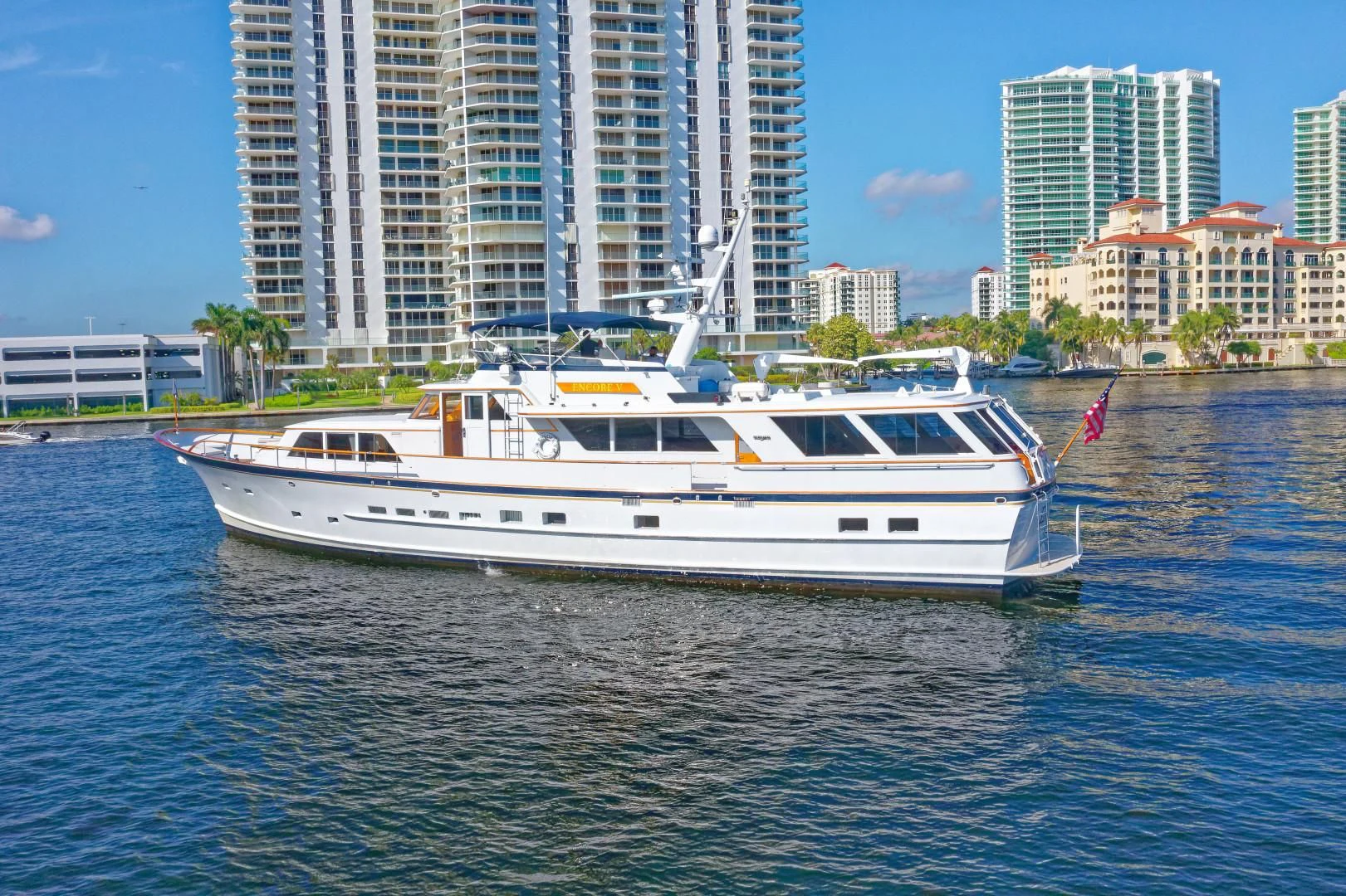 a white boat in the water aboard ENCORE V Yacht for Sale