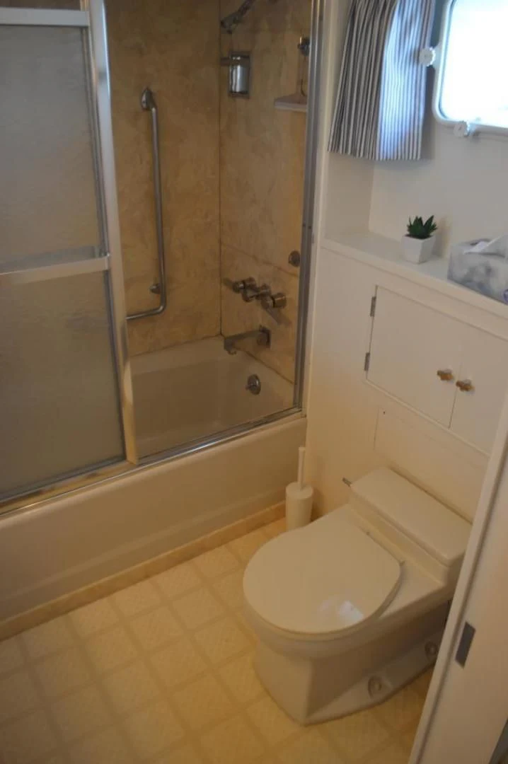 a bathroom with a glass shower aboard ENCORE V Yacht for Sale
