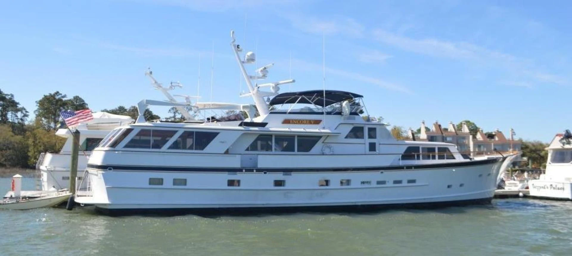 a large white boat in the water aboard ENCORE V Yacht for Sale