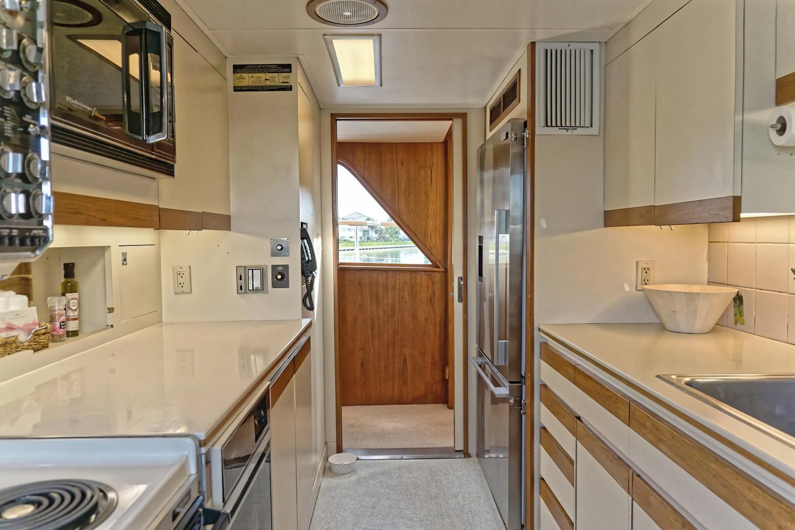 a kitchen with a sink and microwave aboard ENCORE V Yacht for Sale