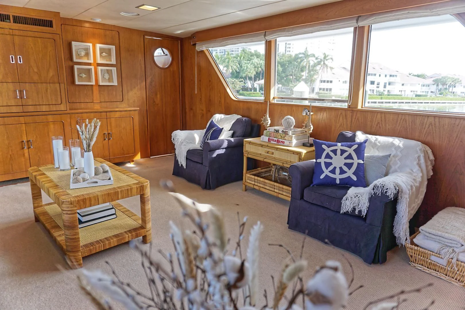 a living room with a blue couch and a coffee table aboard ENCORE V Yacht for Sale