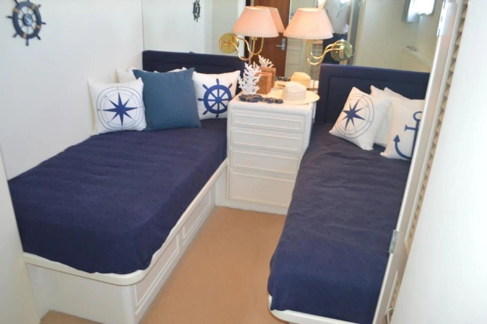 a bedroom with a bed and a dresser aboard ENCORE V Yacht for Sale