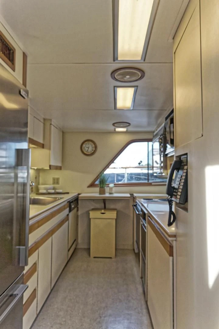 a kitchen with a large window aboard ENCORE V Yacht for Sale