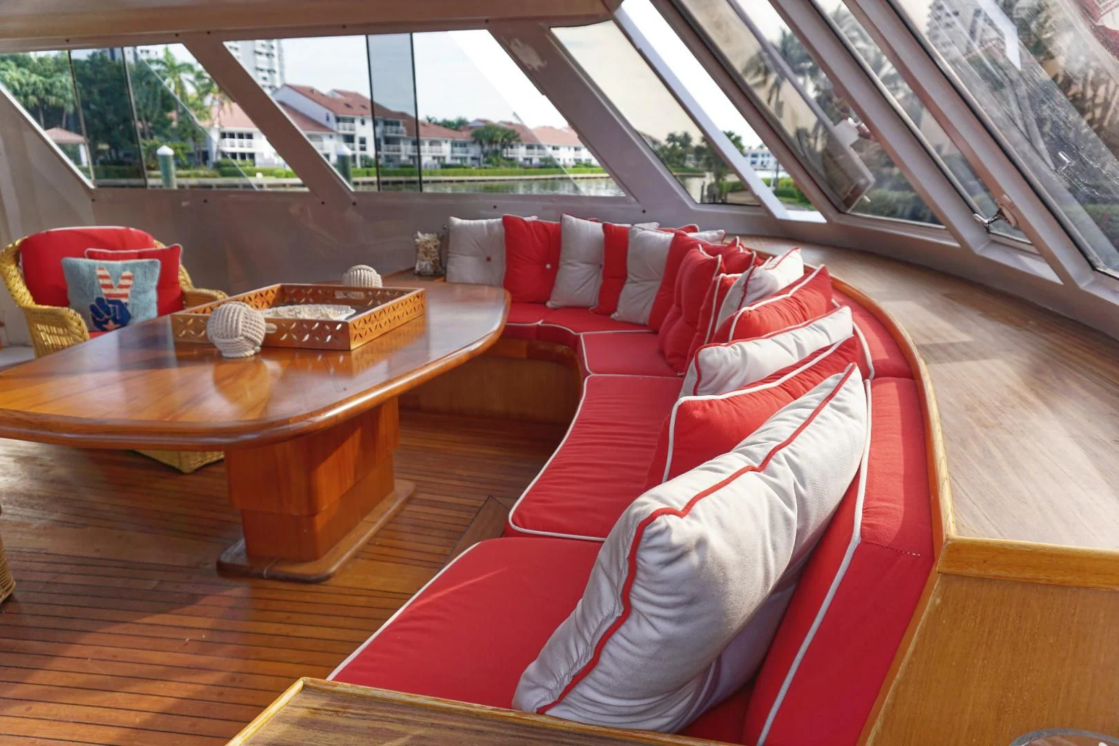 a couch and table in a room aboard ENCORE V Yacht for Sale