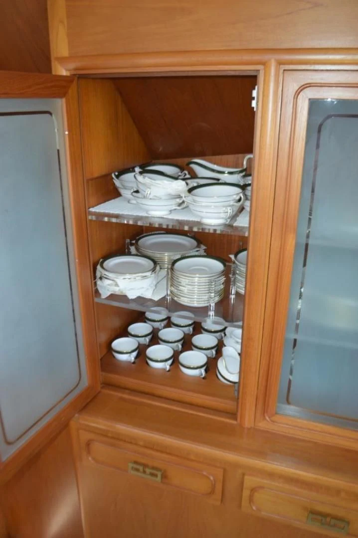 a cabinet with a dishwasher and plates on it aboard ENCORE V Yacht for Sale