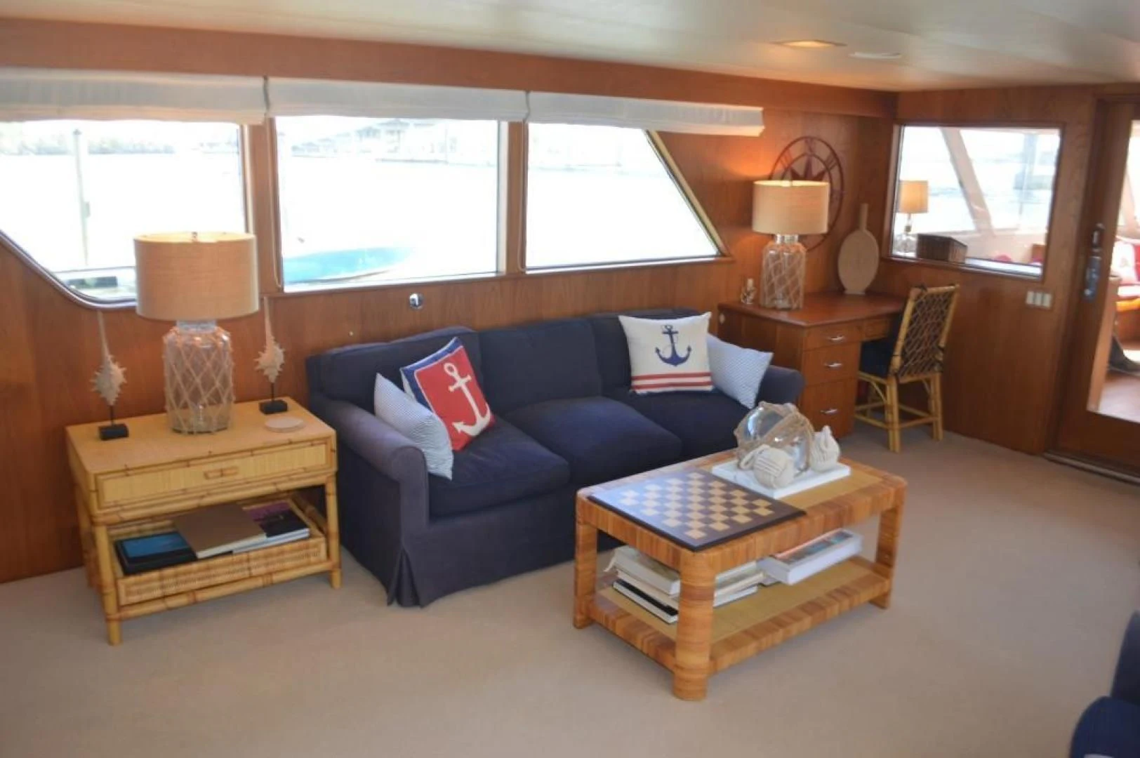 a living room with a blue couch aboard ENCORE V Yacht for Sale