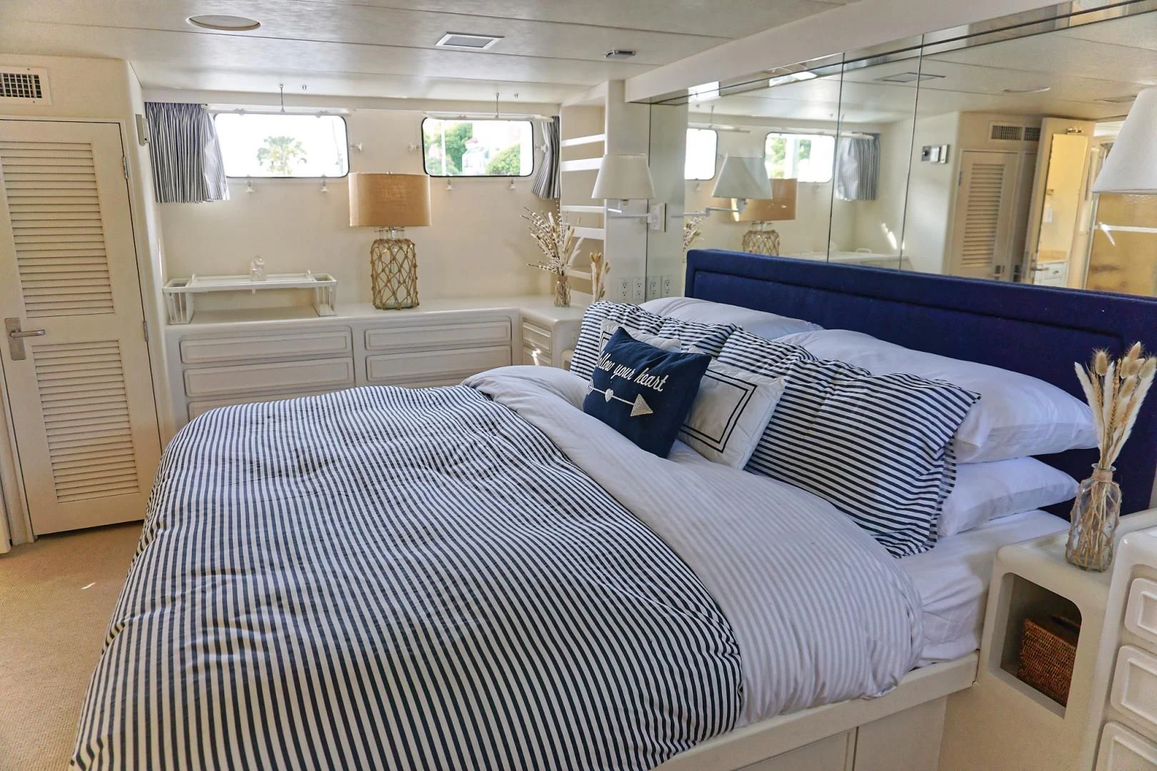 a room with a bed and a television aboard ENCORE V Yacht for Sale