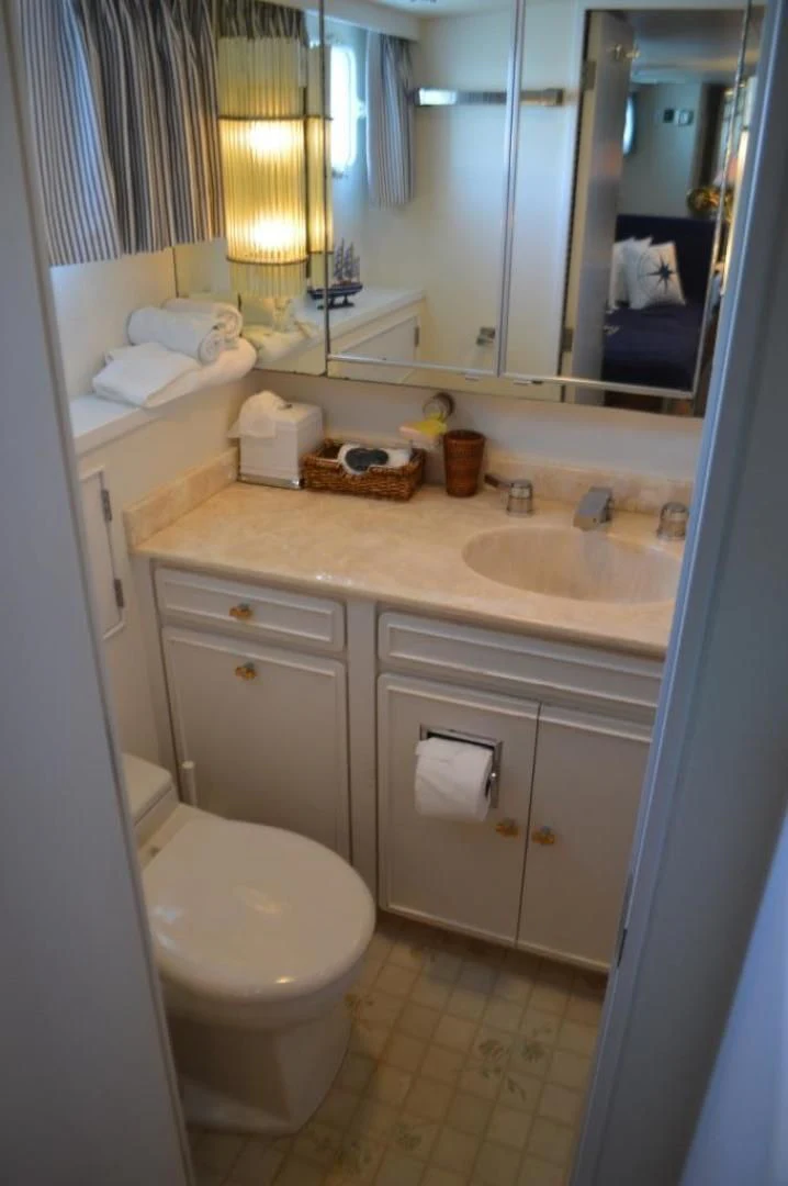 a bathroom with a sink and toilet aboard ENCORE V Yacht for Sale