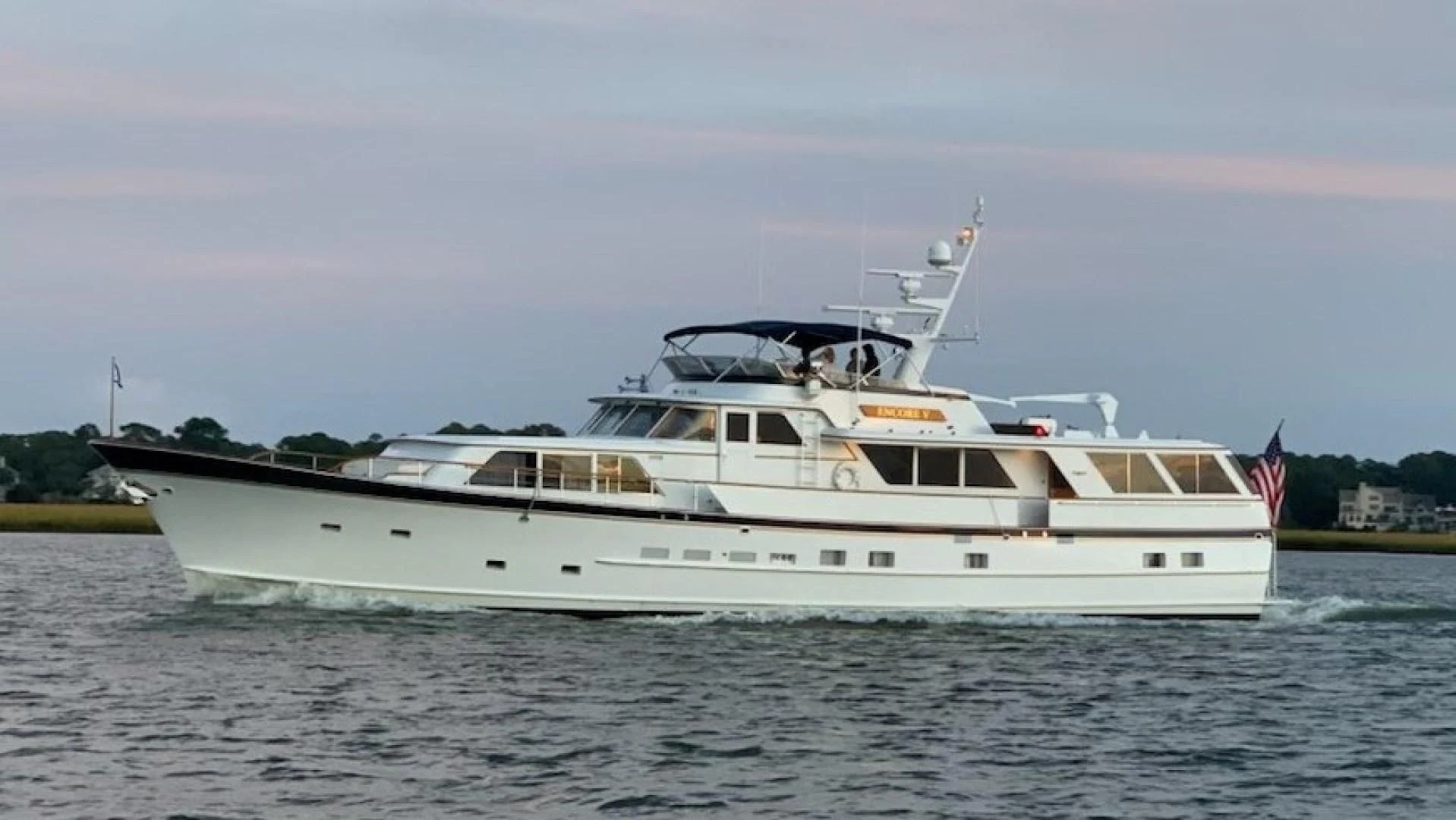 a large white boat on the water aboard ENCORE V Yacht for Sale