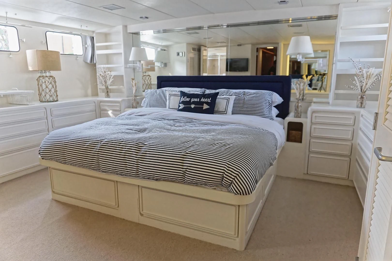 a bedroom with a bed and a desk aboard ENCORE V Yacht for Sale