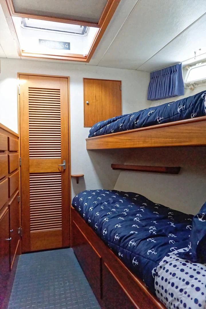 a room with bunk beds aboard ENCORE V Yacht for Sale