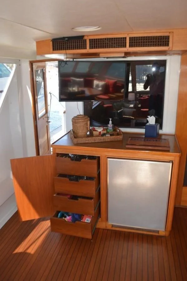 a wooden cabinet with a tv on it aboard ENCORE V Yacht for Sale