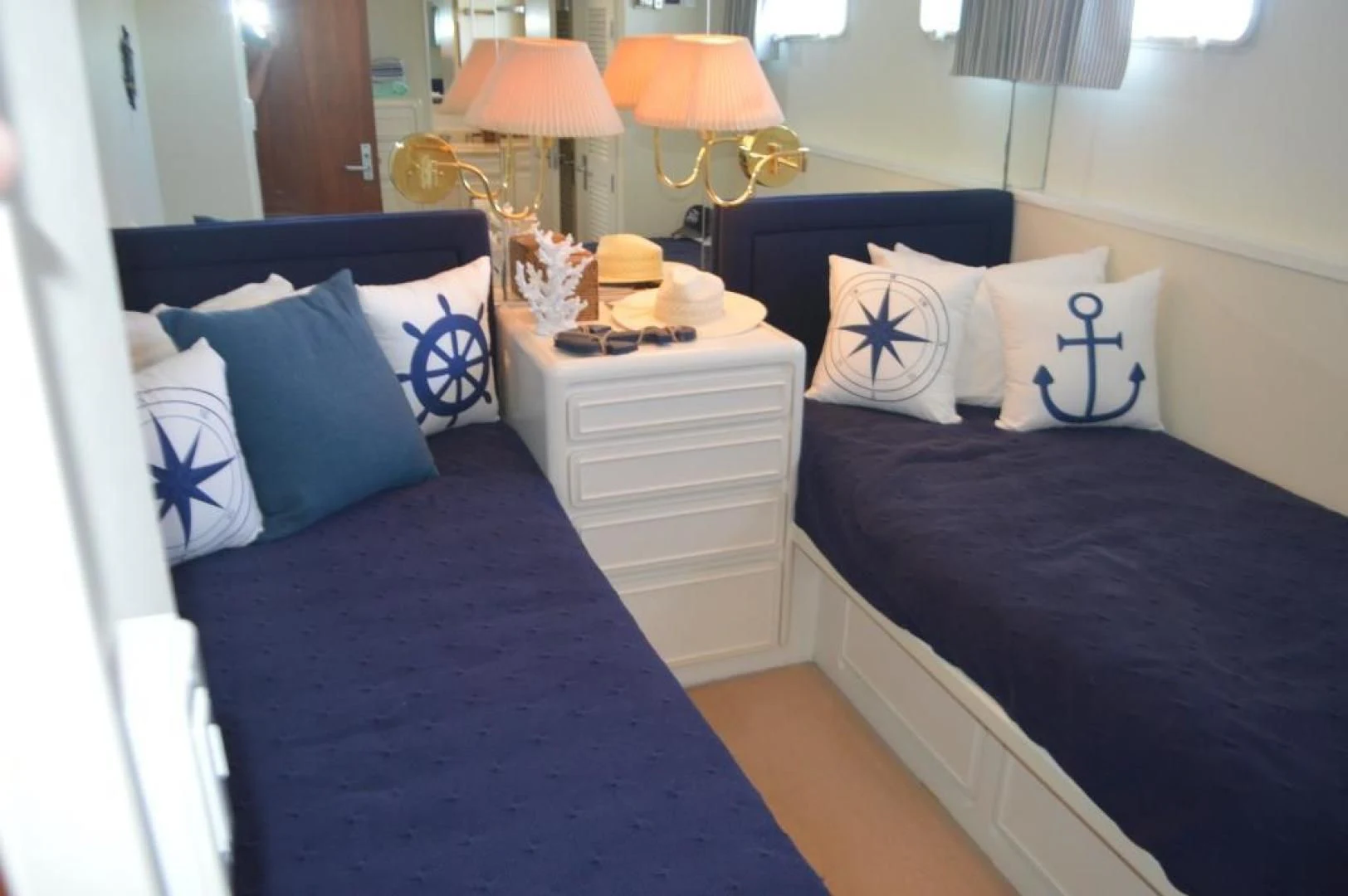 a bedroom with a bed and a lamp aboard ENCORE V Yacht for Sale