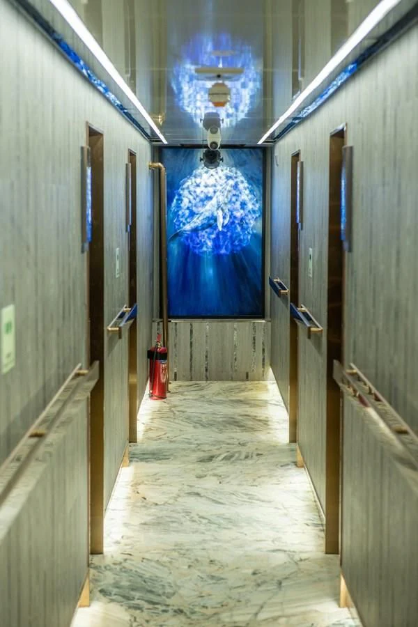 a room with a door and a light on the wall aboard INFINITY X Yacht for Sale