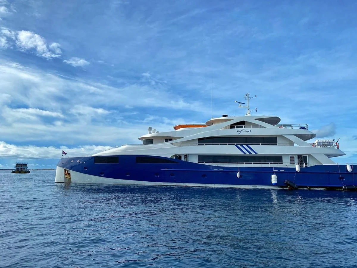 a large blue and white boat in the water aboard INFINITY X Yacht for Sale