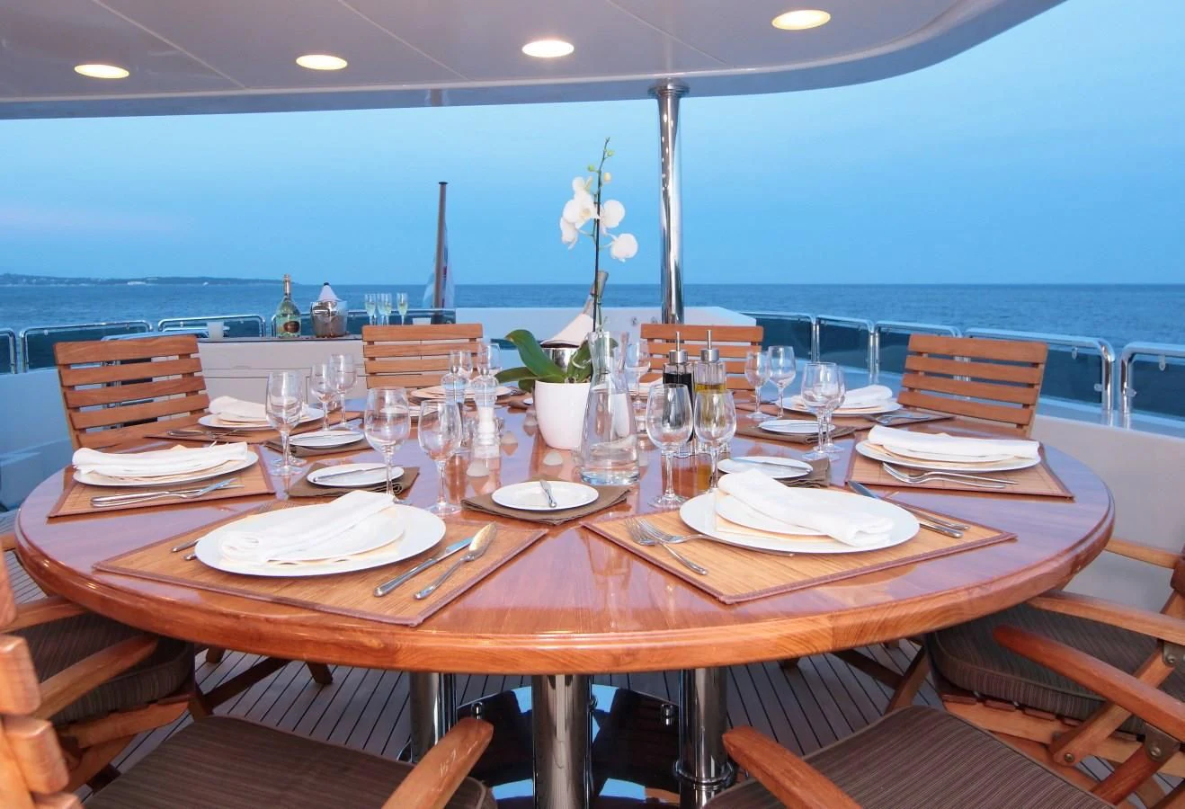 a table with plates and glasses on it aboard INOUIS Yacht for Charter