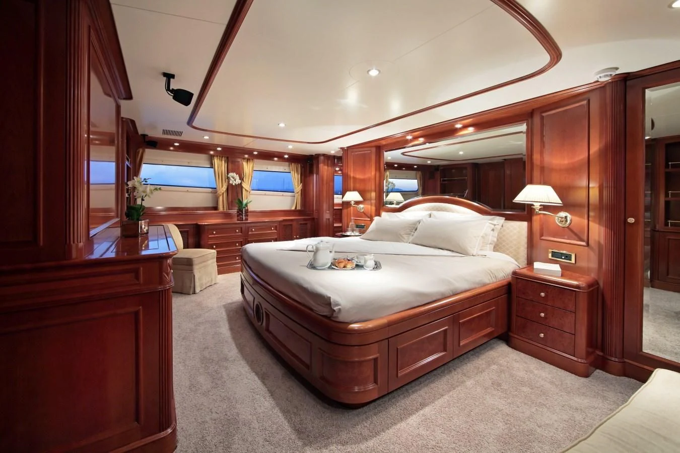 a bedroom with a bed and a dresser aboard INOUIS Yacht for Charter