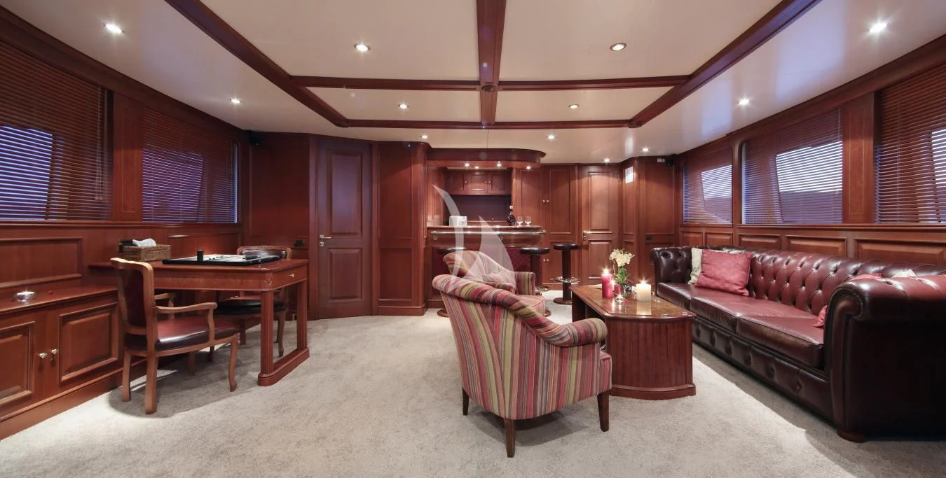a living room with a couch and a table aboard INOUIS Yacht for Charter