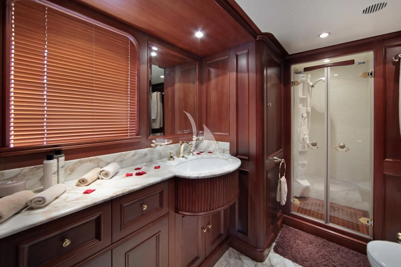 a bathroom with a sink and a shower aboard INOUIS Yacht for Charter
