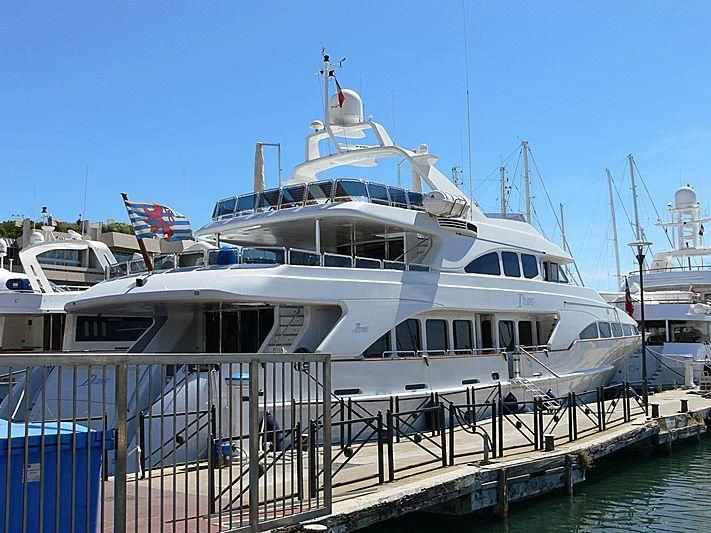 a large white yacht docked at a pier aboard INOUIS Yacht for Charter