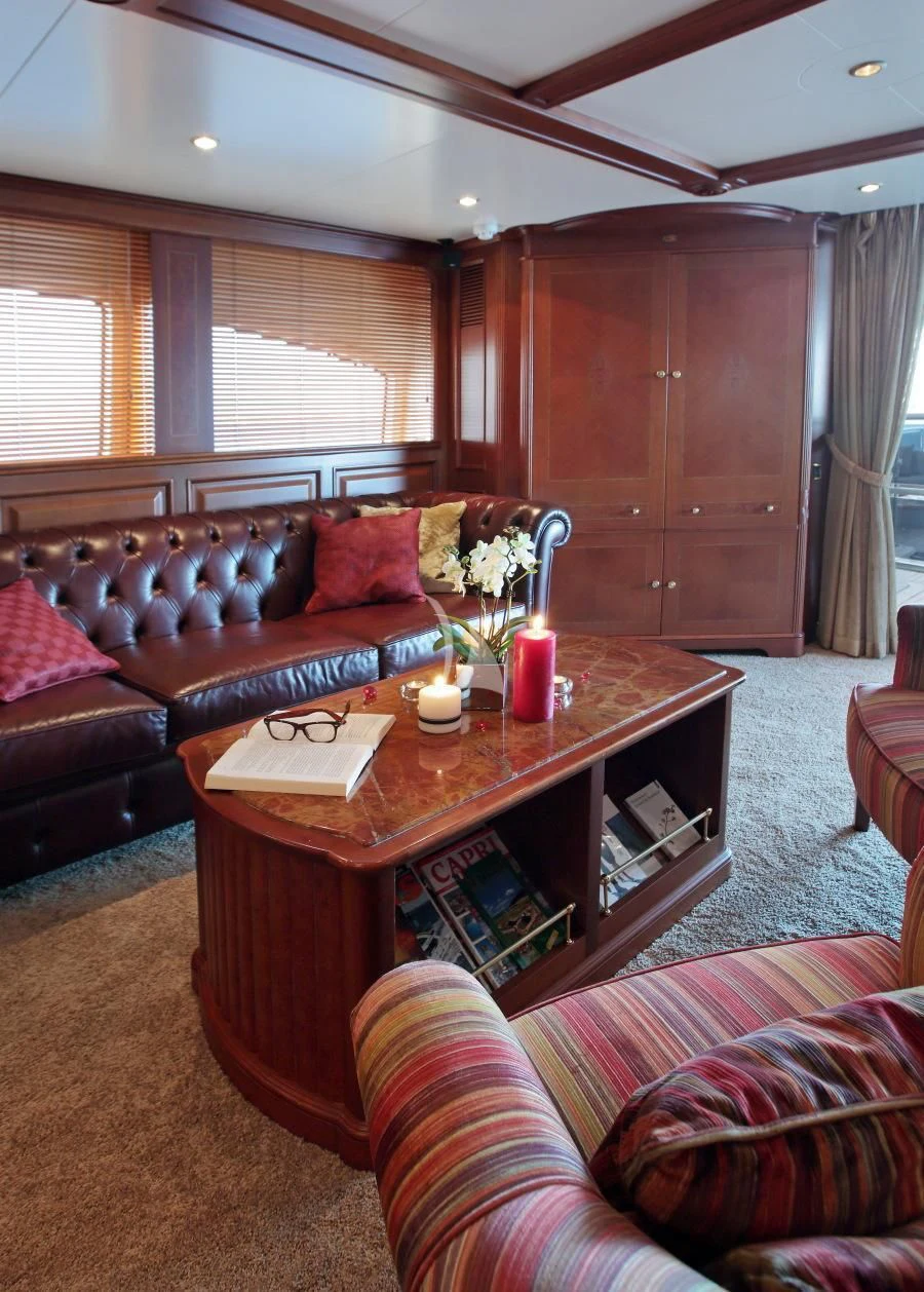 a living room with a coffee table and couches aboard INOUIS Yacht for Charter