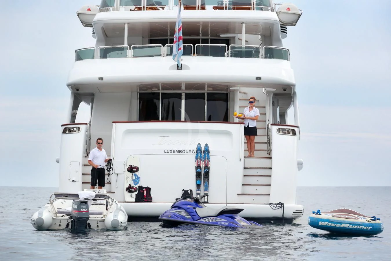 a couple of men standing on a boat on the water aboard INOUIS Yacht for Charter