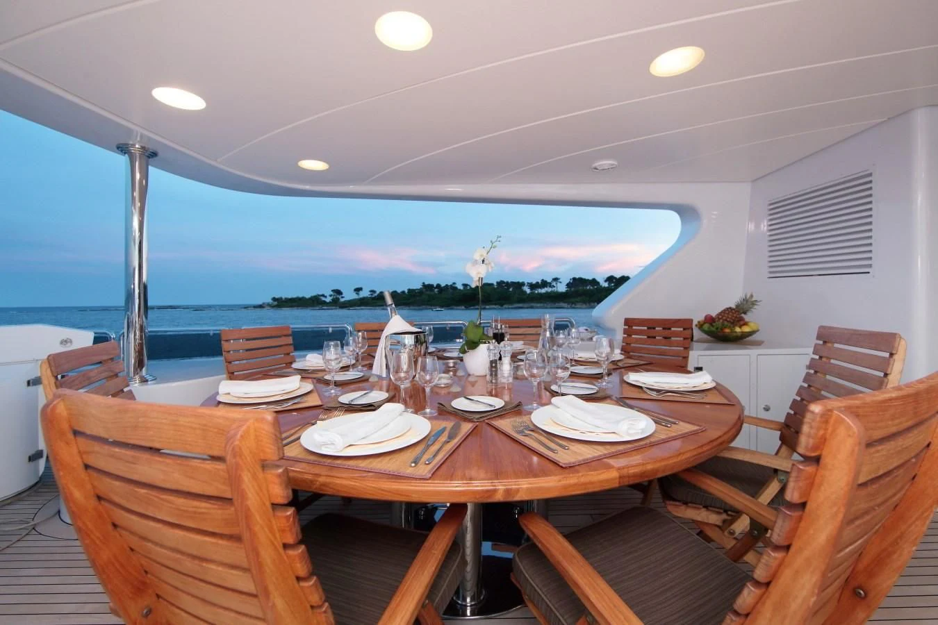 a table with plates and glasses on it aboard INOUIS Yacht for Charter