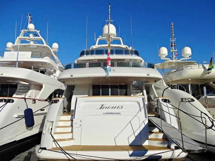 a group of boats in a harbor aboard INOUIS Yacht for Charter