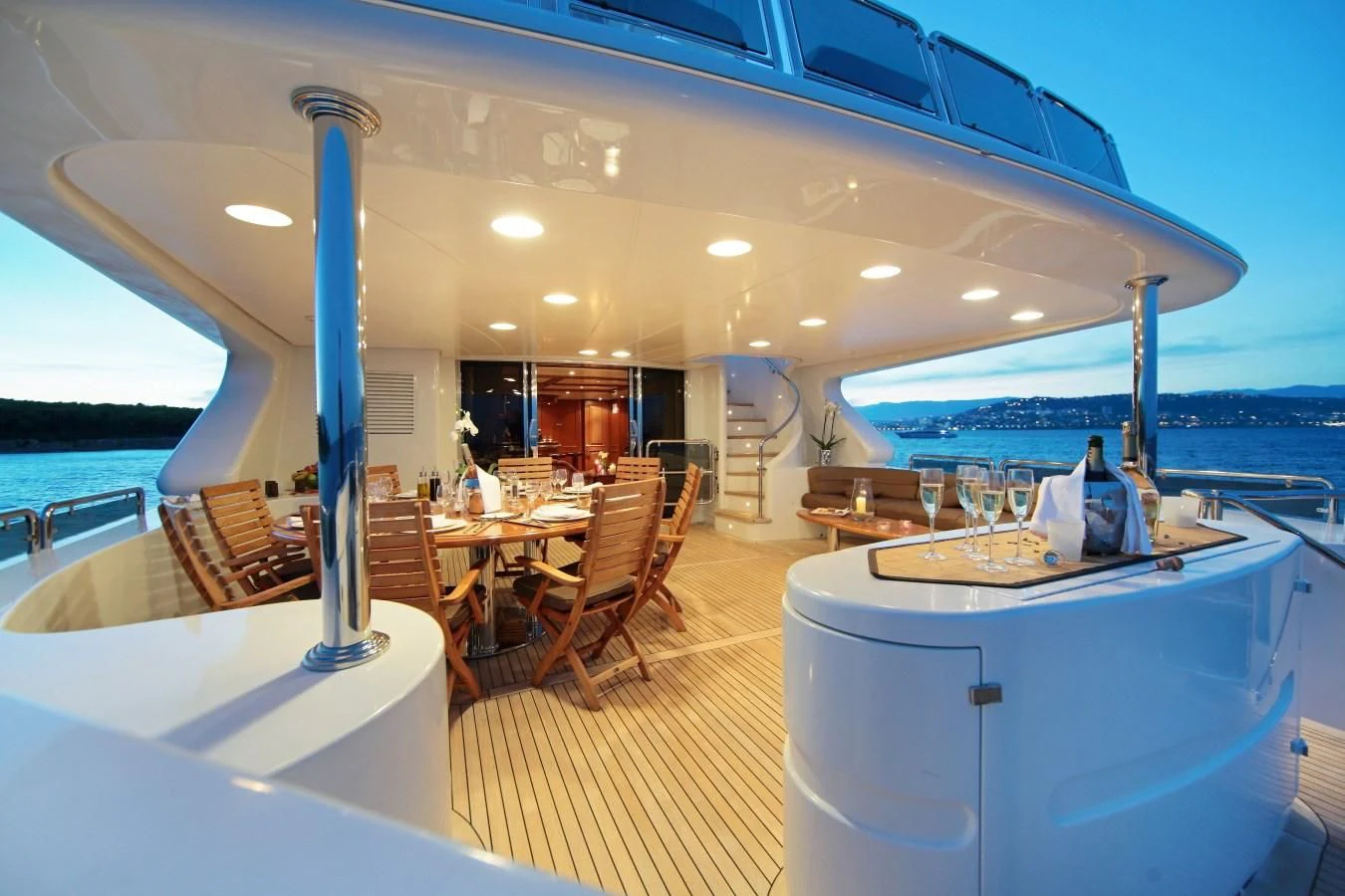 a room with tables and chairs aboard INOUIS Yacht for Charter