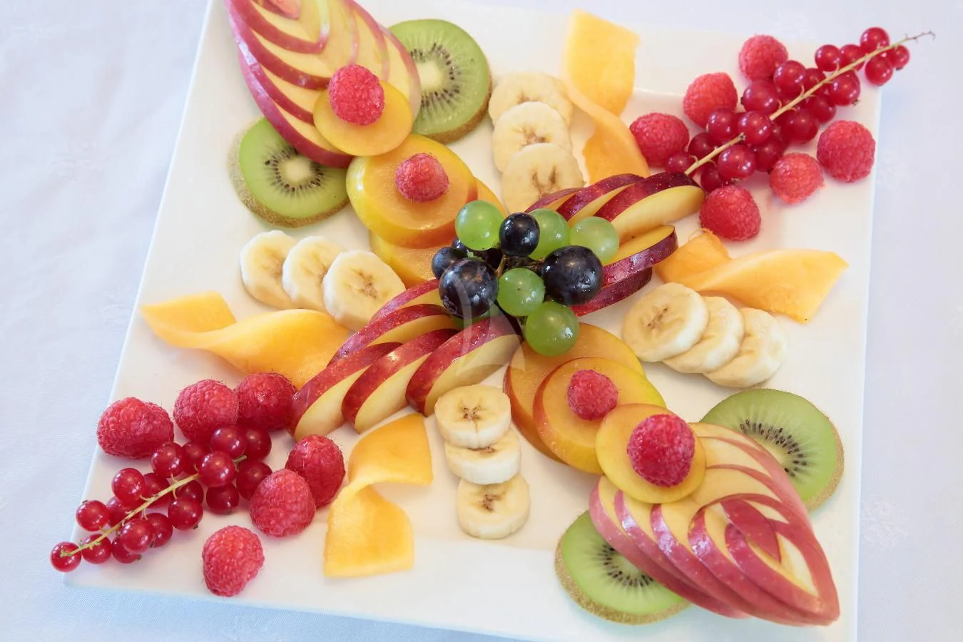 a cake with fruit on it aboard INOUIS Yacht for Charter