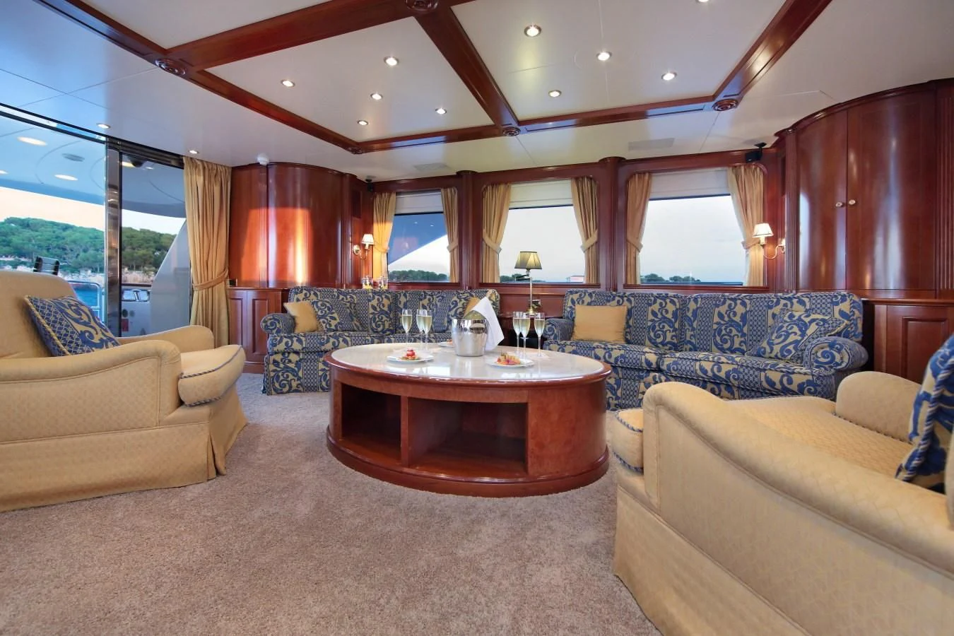a living room with a table and couches aboard INOUIS Yacht for Charter