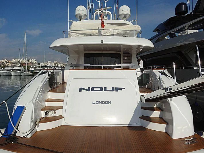 a white boat in a harbor aboard NOUF Yacht for Sale