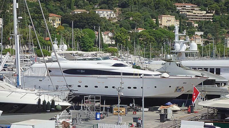 a large white yacht docked at a pier aboard NOUF Yacht for Sale