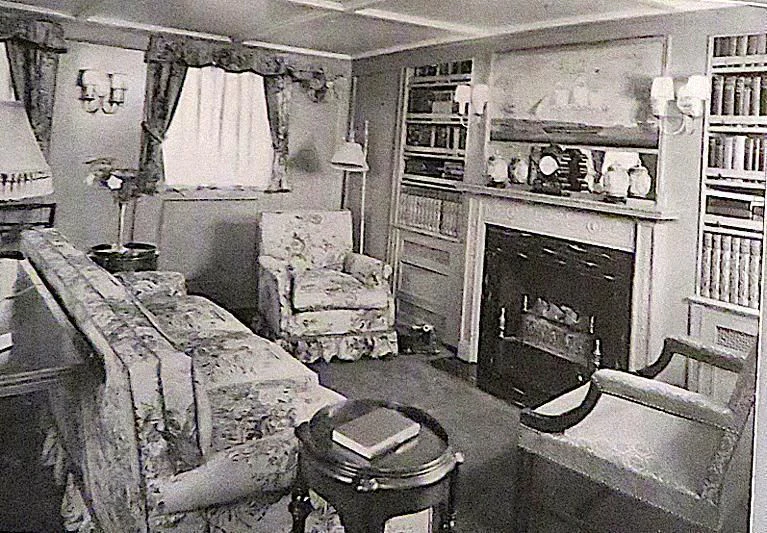 a room with a bed and a bookcase aboard UTHINGO Yacht for Sale