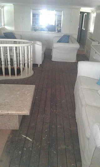 a room with a table and chairs aboard UTHINGO Yacht for Sale
