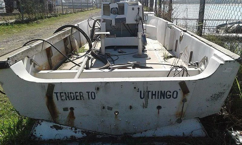 a white boat with a black and white body and a white object on it aboard UTHINGO Yacht for Sale