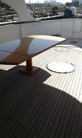 a table on a deck aboard UTHINGO Yacht for Sale
