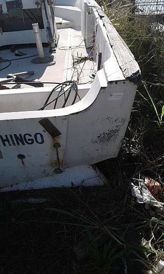 a white boat in a yard aboard UTHINGO Yacht for Sale