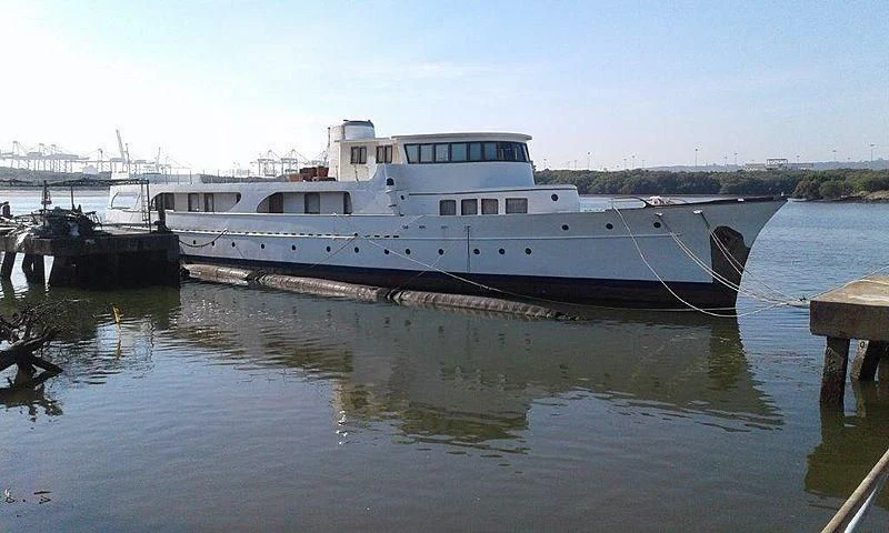 a boat docked at a pier aboard UTHINGO Yacht for Sale