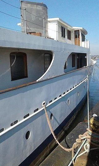 a boat docked at a pier aboard UTHINGO Yacht for Sale