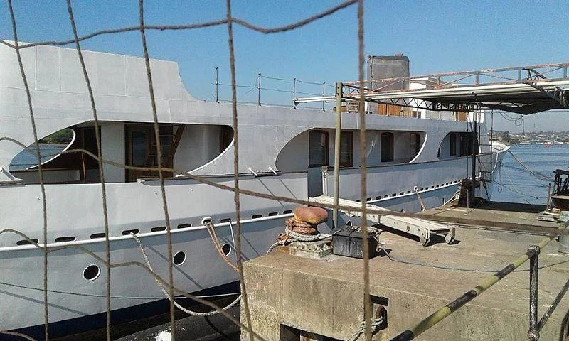 a boat docked at a pier aboard UTHINGO Yacht for Sale