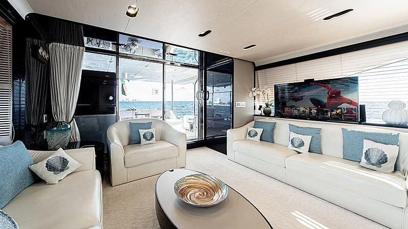 a living room with a large window aboard TEMPTATION Yacht for Sale