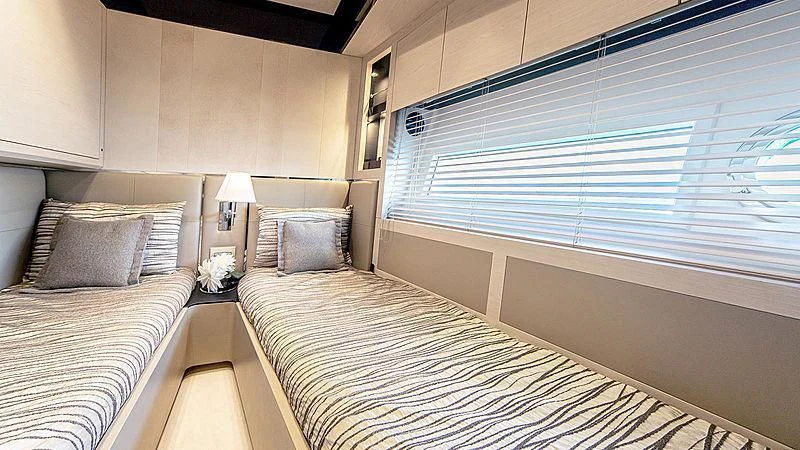 a room with two beds aboard TEMPTATION Yacht for Sale