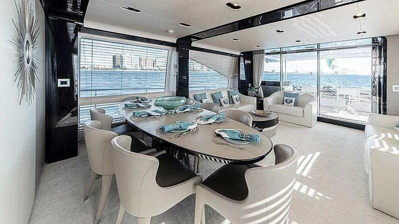 a large living room with a large glass window aboard TEMPTATION Yacht for Sale