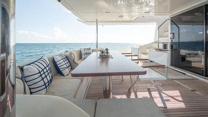 a table on a deck aboard TEMPTATION Yacht for Sale