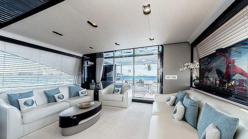 a living room with a large screen aboard TEMPTATION Yacht for Sale