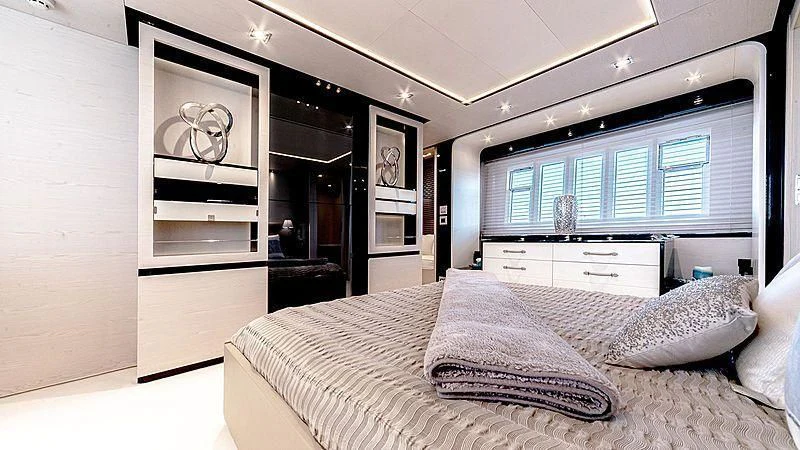 a bedroom with a large mirror aboard TEMPTATION Yacht for Sale