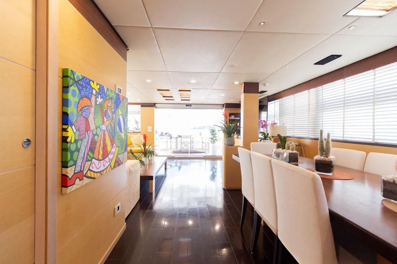 a room with tables and chairs aboard MR GU Yacht for Sale