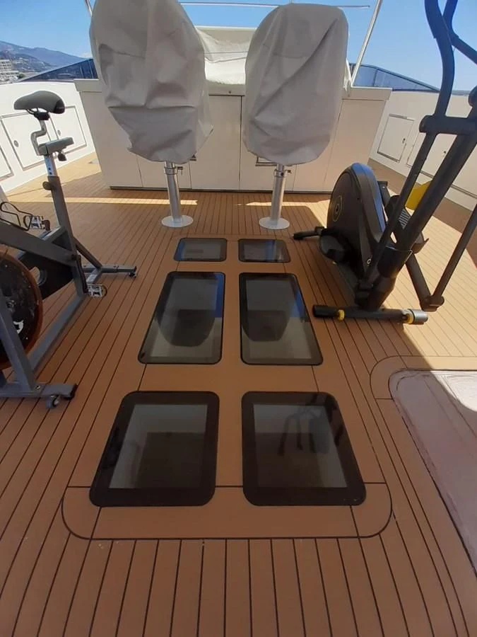 a table with laptops on it aboard MR GU Yacht for Sale